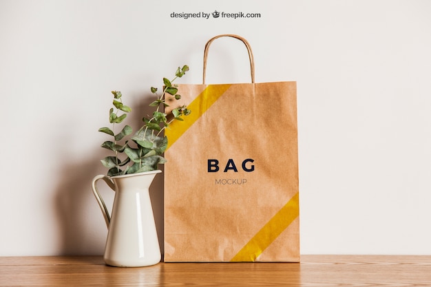 Paper bag mockup next to flower pot | The Web Univers