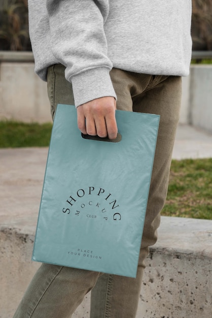 Person holding mock-up plastic bag design | The Web Univers