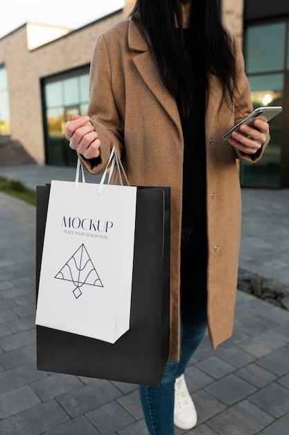 Woman holding luxurious shopping bag outdoors | The Web Univers