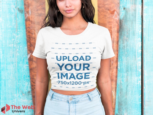 Hispanic Woman Wearing a Tshirt Mockup Standing Against a Surfboard | The Web Univers