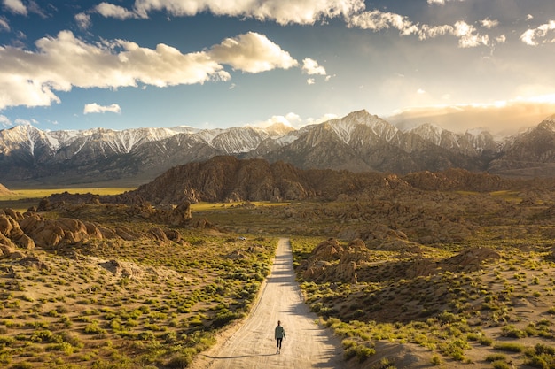 Lonely person walking on a pathway in alabama hills in california with mount whitney | The Web Univers