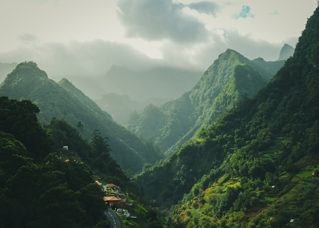 Mesmerizing scenery of green mountains with cloudy sky surface | The Web Univers