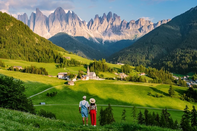 Couple viewing the landscape of santa maddalena village in dolomites italy santa magdalena village | The Web Univers
