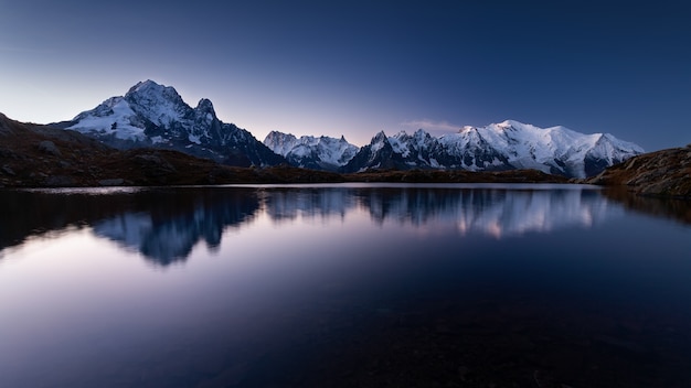 Mount mont blanc covered in the snow reflecting on the water in the evening in chamonix, france | The Web Univers
