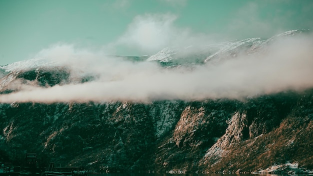 A mountain range with a green sky and clouds | The Web Univers