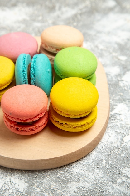 Front view yummy french macarons colorful cakes on the white desk cake pie sugar biscuit sweet cookie | The Web Univers