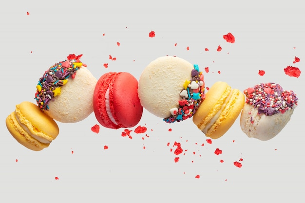Colorful macarons cookies. french cakes. sweet and colorful french macaroons fall or fly in motion. with slices | The Web Univers